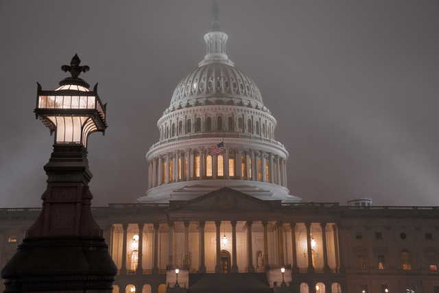 The U.S. Capitol in Washington is shrouded in mist, Friday night, Dec. 13, 2019. This coming week’s virtually certain House impeachment of President Donald Trump will underscore how Democrats and Republicans have morphed into fiercely divided camps since lawmakers impeached President Bill Clinton.(AP Photo/J.