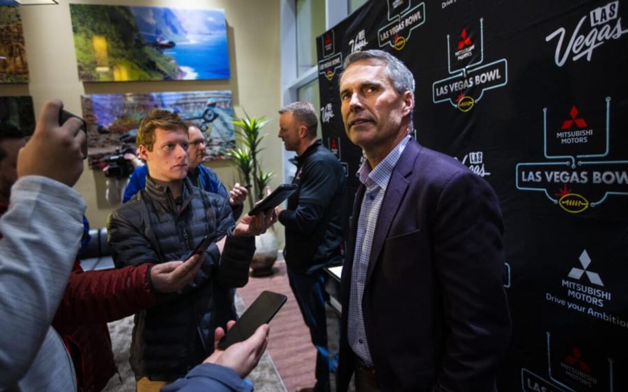 Washington head coach Chris Petersen speaks with reporters ahead of the Las Vegas Bowl NCAA college football game in Las Vegas, Tuesday, Dec. 17, 2019.