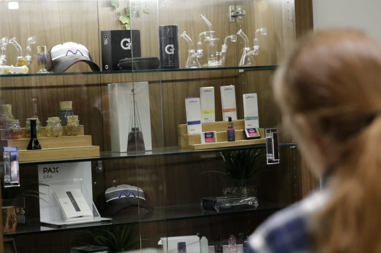 A registered medical marijuana patient looks Thursday at products at the Rise cannabis store in Mundelein, Ill. On Jan. 1, Illinois will join Michigan as the only Midwestern states broadly allowing the sale and use of marijuana. (Nam Y.