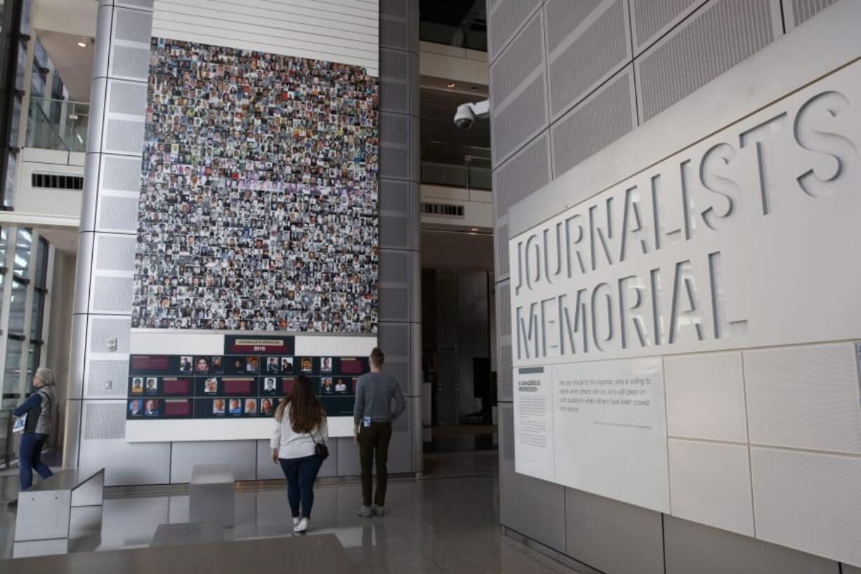 People visit the journalists memorial Friday at the Newseum in Washington.