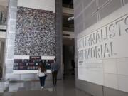 People visit the journalists memorial Friday at the Newseum in Washington.