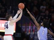 Gonzaga forward Corey Kispert (24) shoots over North Carolina guard Leaky Black (1) during the first half of an NCAA college basketball game in Spokane, Wash., Wednesday, Dec. 18, 2019.