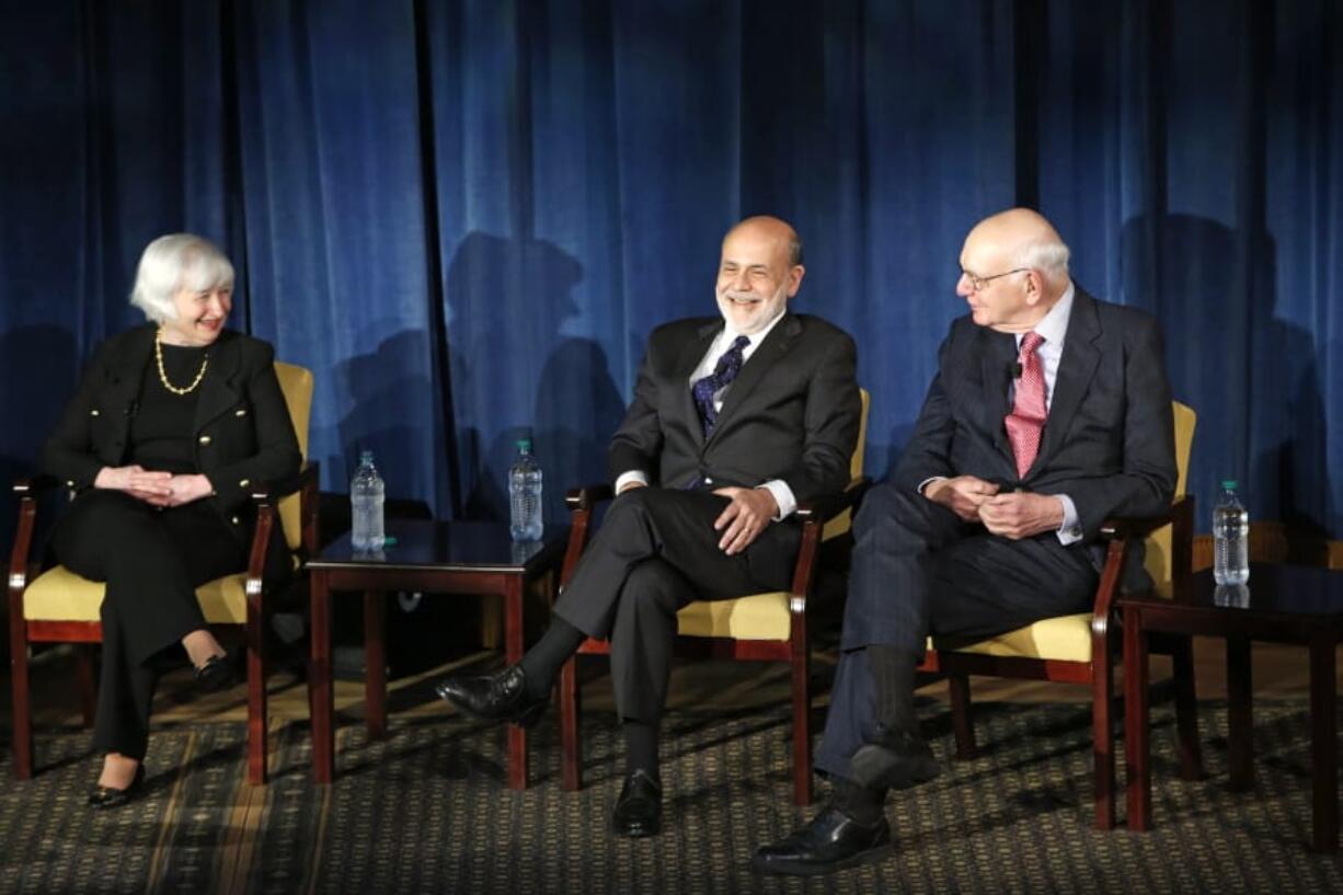 FILE - In this April 7, 2016, file photo Federal Reserve chair Janet Yellen, left, and former Federal Reserve chairs Ben Bernanke, center, and Paul Volcker, right, react as they listen to former Fed Chair Alan Greenspan appearing via video conference, during a panel discussion in New York. Volcker, the former Federal Reserve chairman died on Sunday, Dec. 8, 2019, according to his office, He was 92.