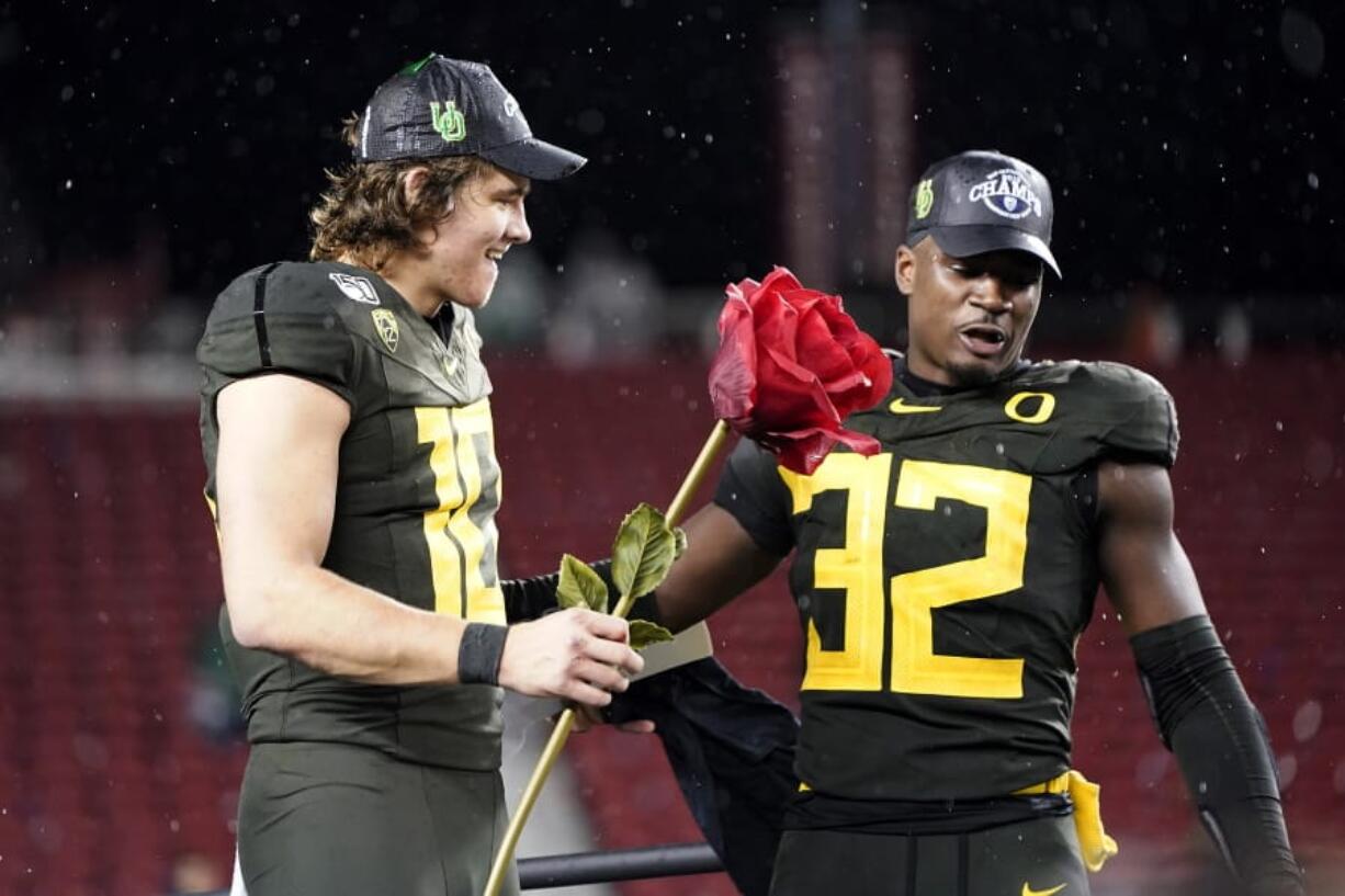 Oregon quarterback Justin Herbert (10) and teammate La&#039;Mar Winston Jr. (32) celebrate after Oregon defeated Utah 37-15 in an NCAA college football game for the Pac-12 Conference championship in Santa Clara, Calif., Friday, Dec. 6, 2018.