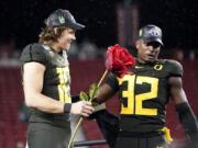 Oregon quarterback Justin Herbert (10) and teammate La&#039;Mar Winston Jr. (32) celebrate after Oregon defeated Utah 37-15 in an NCAA college football game for the Pac-12 Conference championship in Santa Clara, Calif., Friday, Dec. 6, 2018.