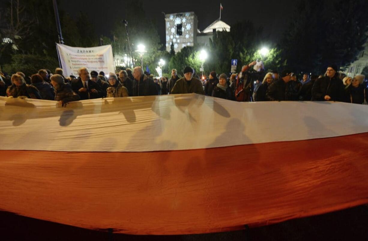 Demonstrators hold a rally to protest against changes to Poland&#039;s judiciary planned by the ruling Law and Justice party near the building of parliament in Warsaw, Poland, Wednesday, Dec. 18, 2019.