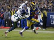 Los Angeles Rams running back Todd Gurley, right, scores past Seattle Seahawks cornerback Tre Flowers during the second half of an NFL football game Sunday, Dec. 8, 2019, in Los Angeles.