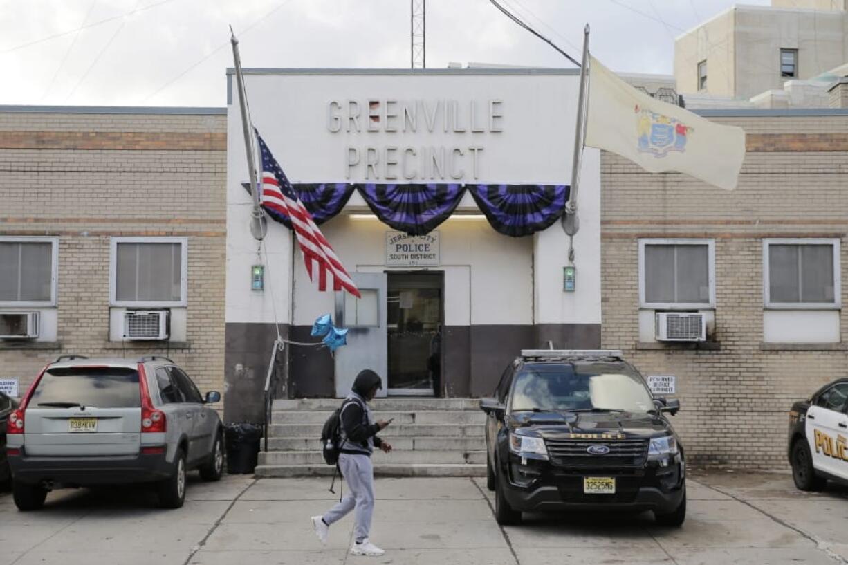 Bunting hangs on the Greenville precinct in Jersey City, N.J., Wednesday, Dec. 11, 2019. The two gunmen in a furious firefight that left multiple people dead in Jersey City clearly targeted a Jewish market, the mayor said Wednesday, amid growing suspicions the bloodshed was an anti-Semitic attack. The shooting began near a cemetery, where Detective Joseph Seals, a 40-year-old member of a unit devoted to taking illegal guns off the street, was killed while trying to stop &quot;bad guys,&quot; Police Chief Michael Kelly said without elaborating.