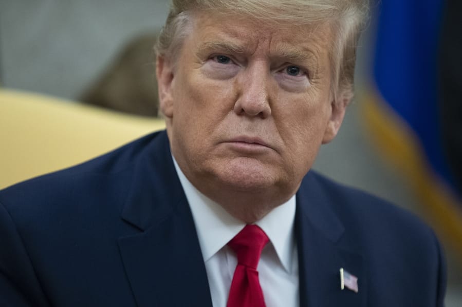 President Donald Trump listens to a question during a meeting with Guatemalan President Jimmy Morales in the Oval Office of the White House, Tuesday, Dec. 17, 2019, in Washington.