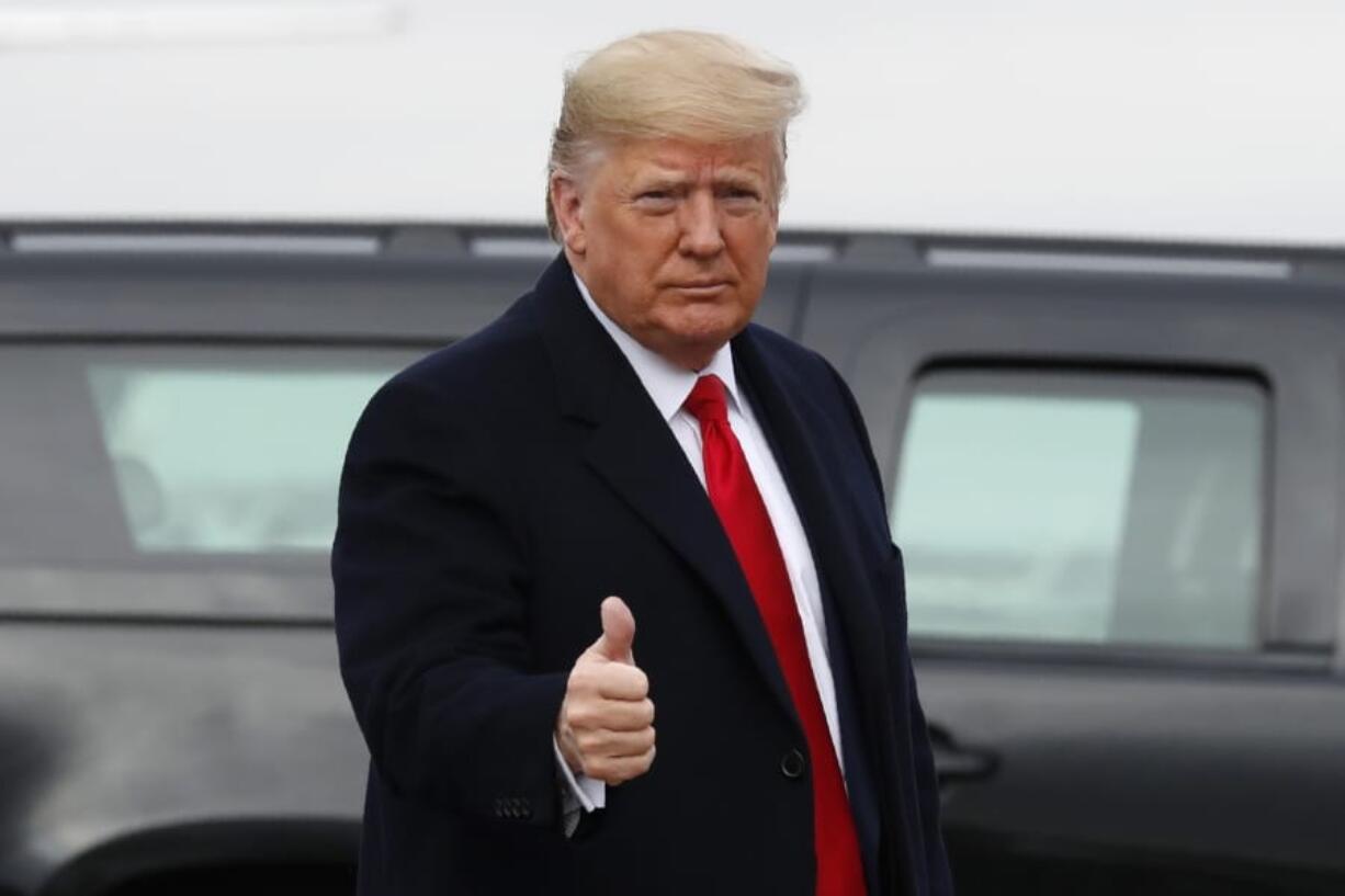 President Donald Trump makes the thumbs up sign as he exits a motorcade to board Air Force One at Andrews Air Force Base, Md., Saturday, Dec. 14, 2019, en route to Philadelphia to attend the Army-Navy football game.