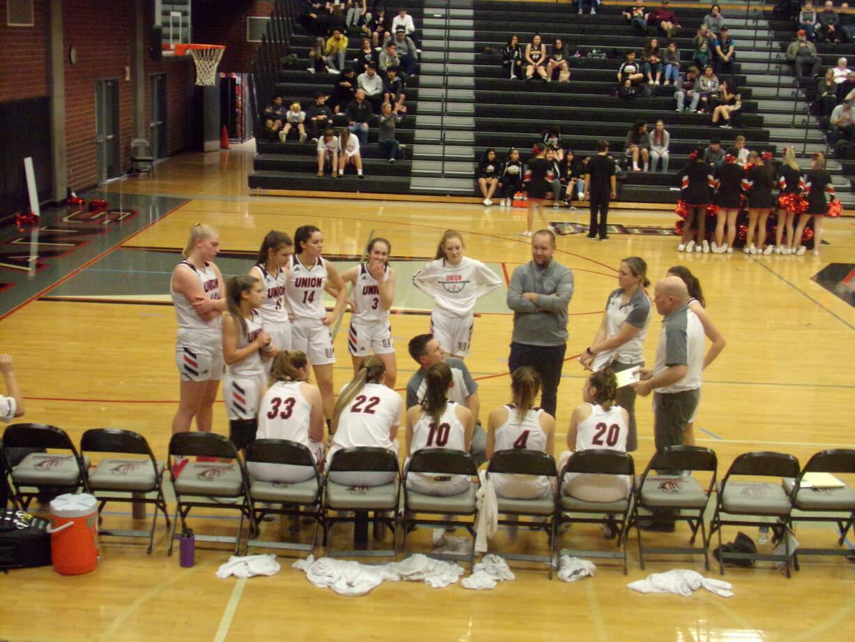 Union girls basketball coach Gary Mills talks to his players during a timeout. The Titans beat Hudson's Bay 76-38 on Monday, Dec.