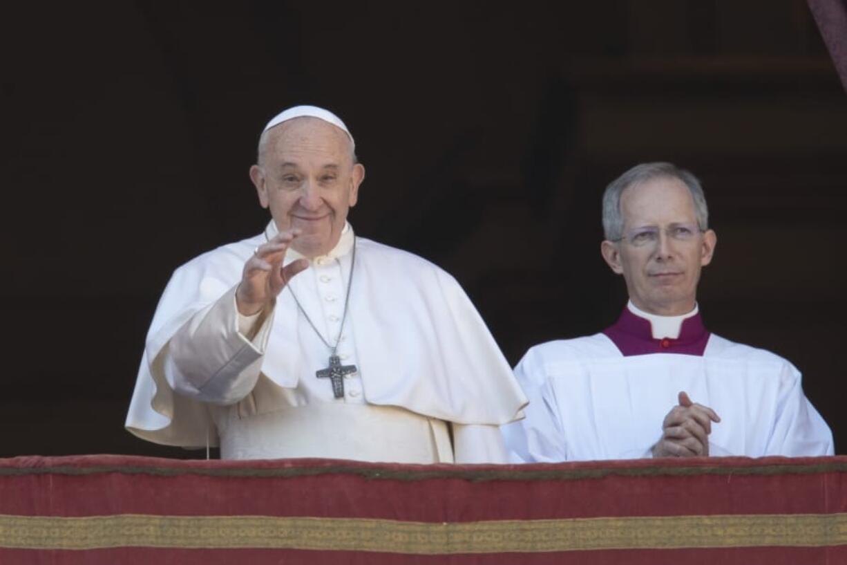 Pope Francis, flanked by Mons. Guido Marini, the Vatican master of liturgical ceremonies, waves to faithful and pilgrims after he delivered the Urbi et Orbi (Latin for &#039;to the city and to the world&#039; ) Christmas&#039; day blessing from the main balcony of St. Peter&#039;s Basilica at the Vatican, Wednesday, Dec. 25, 2019.