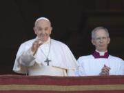 Pope Francis, flanked by Mons. Guido Marini, the Vatican master of liturgical ceremonies, waves to faithful and pilgrims after he delivered the Urbi et Orbi (Latin for &#039;to the city and to the world&#039; ) Christmas&#039; day blessing from the main balcony of St. Peter&#039;s Basilica at the Vatican, Wednesday, Dec. 25, 2019.