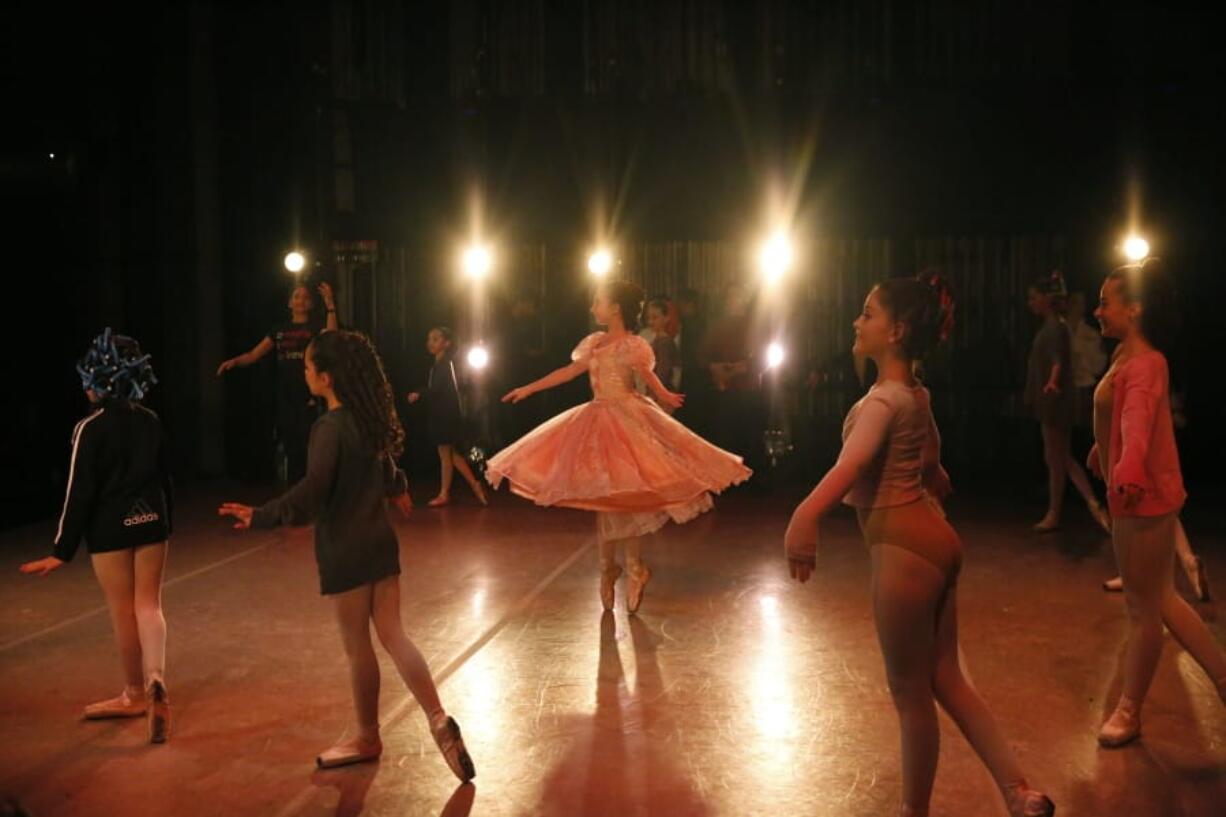 Young dancers perform on stage during a rehearsal of Vladimir Issaev&#039;s rendition of The Nutcracker ballet on Friday, Dec. 13, 2019, in Fort Lauderdale, Fla. More than 20 dancers of Venezuelan origin were playing various roles on a recent performance of the holiday favorite &quot;The Nutcracker.&quot; Some of these dancers are here seeking asylum after fleeing their crisis-torn nation, which is plagued by shortages of food and medicine.