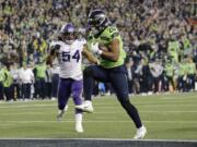 Seattle Seahawks' Rashaad Penny high steps into the end zone for a touchdown against the Minnesota Vikings during the second half of an NFL football game, Monday, Dec. 2, 2019, in Seattle.