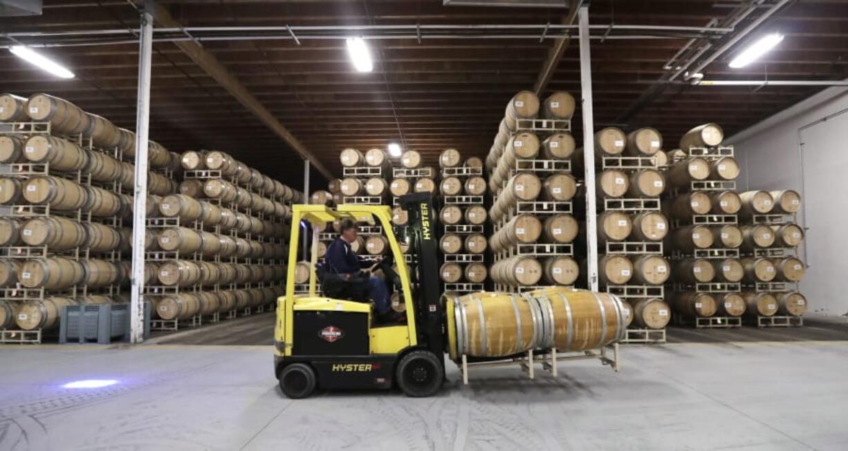 In this photo taken Thursday, Nov. 21, 2019, barrels of wine are moved into storage at Chateau Ste. Michelle winery in Woodinville, Wash. From less than 20 wineries in 1981, the Washington wine industry has grown to more than 1,000 this year. And the growth is likely to continue.