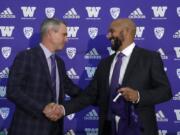 Washington NCAA college football head coach Chris Petersen, left, shakes hands with defensive coordinator Jimmy Lake following a news conference about Lake taking over the head coaching position, Tuesday, Dec. 3, 2019, in Seattle. Petersen unexpectedly resigned on Monday, a shocking announcement with the Huskies coming off a 7-5 regular season and bound for a sixth straight bowl game under his leadership. Petersen will coach Washington in a bowl game, his final game in charge.