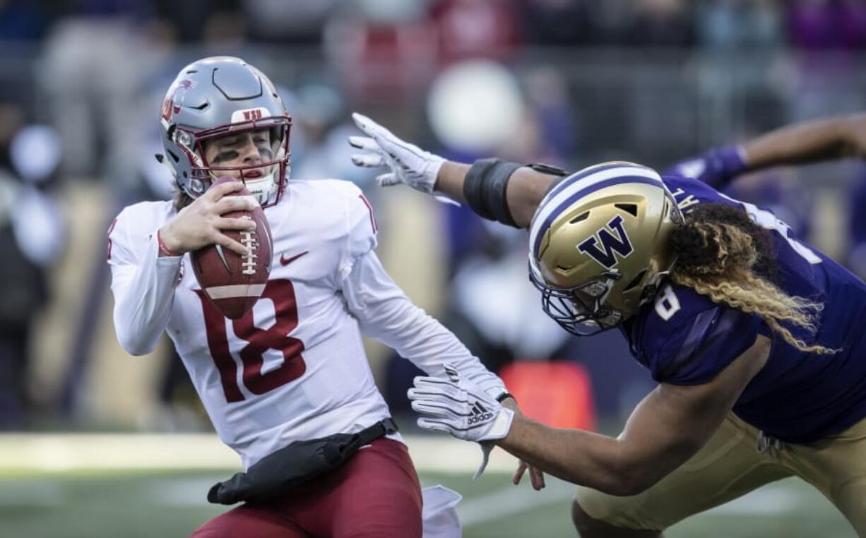 Washington State quarterback Anthony Gordon tries to escape the grasp of Washington defensive lineman Benning Potoa&#039;e during the first half an NCAA college football game, on Friday, Nov. 29, 2019 in Seattle.