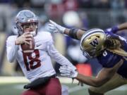 Washington State quarterback Anthony Gordon tries to escape the grasp of Washington defensive lineman Benning Potoa&#039;e during the first half an NCAA college football game, on Friday, Nov. 29, 2019 in Seattle.