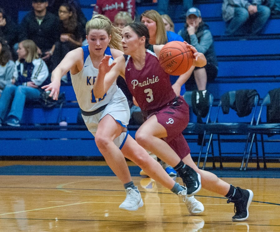 Prairie&#039;s Meri Dunford drives past Kelso&#039;s Cooper Joy in a 44-29 3A Greater St. Helens Leauge victory on Thursday. Dunford led the Falcons with 10 points.