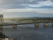 The I-5 Bridge stretches over the Columbia River at sunrise.