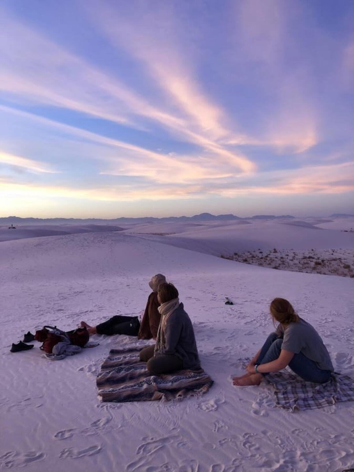 Campers catch the sunset on top of the dunes in White Sands National Park in New Mexico.