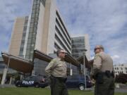 Clark County Undersheriff Mike Cooke, left, talks with Chief Criminal Deputy John Chapman during a 2017 incident at PeaceHealth Southwest Medical Center. Cooke is retiring, and Chapman will take his place as undersheriff.