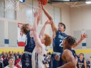 King&#039;s Way Christian&#039;s Justin Frahm, right, grabs a rebound over teammate Bryson Metz and Seton Catholic&#039;s Andrew Olson in the Knights&#039; 75-65 win on Wednesday.