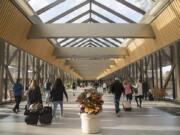 Passengers walk through Norfolk International Airport in Norfolk, Va.