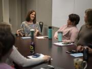 Clinical supervisor Brook Vejo, center, talks with the Youth Mobile Crisis Intervention team during its meeting at Catholic Community Services in Vancouver. The organization works with teenagers who are in a mental health crisis in an effort to keep them out of the emergency room.