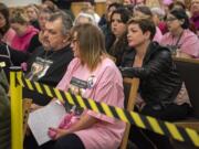 Nikki Kuhnhausen's stepfather Vincent Woods, left, and mother Lisa Woods, right, listen to the judge during the bail review hearing for David Y. Bogdanov at Clark County Superior Court on Thursday morning, Jan. 2, 2020. Judge David Gregerson set $750,000 bail Thursday for Bogdanov, the suspect in the slaying of a transgender Vancouver teen Nikki Kuhnhausen. Transgender activist and advocate Devon Rose Davis, right, comforts Lisa Woods.