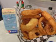 Onion rings at a table with a jukebox at Stardust Diner.