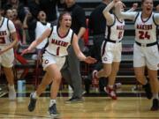 Camas&#039; Haylie Johnson (1) and her teammates celebrate their win after Tuesday night&#039;s game against Union at Camas High School.