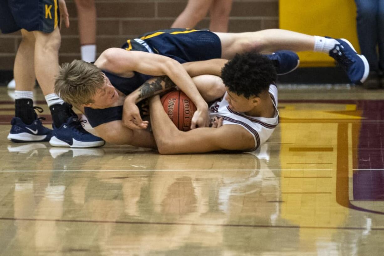 Kelso&#039;s Rees Hall (4) and Prairie&#039;s Mark Frazier (11) fight for the ball during Friday night&#039;s game at Prairie High School in Vancouver on Jan. 10, 2020. Prairie won 44-32.