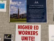 A poster signalling support for the Association for Higher Education hangs in a hallway of faculty offices in Foster Hall at Clark College on Monday afternoon. Faculty are poised to strike Jan. 13 if a deal is not reached between the union and college administration.