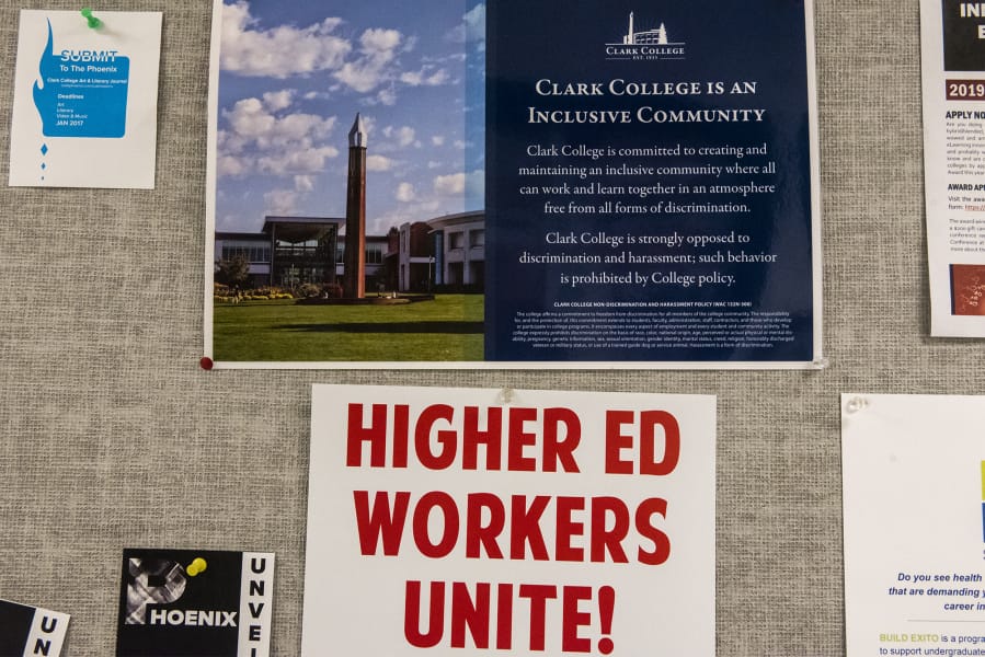 A poster signalling support for the Association for Higher Education hangs in a hallway of faculty offices in Foster Hall at Clark College on Monday afternoon. Faculty are poised to strike Jan. 13 if a deal is not reached between the union and college administration.