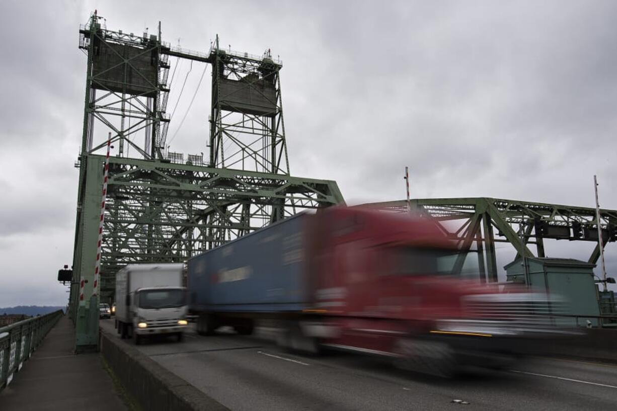 Trucks cross the Interstate 5 Bridge while traveling north on Tuesday morning.