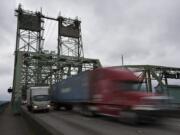 Trucks cross the Interstate 5 Bridge while traveling north on Tuesday morning.