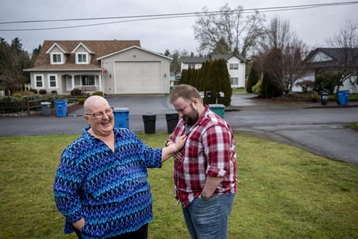 Laurie Burpee, left, jokes with her son, Alec Burpee, while talking about some of the acts that led to a Kindness 911 citation she received in December.