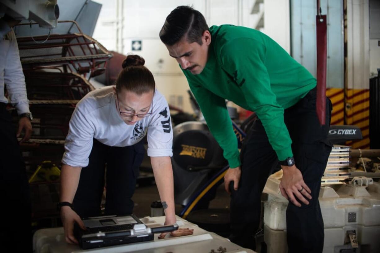 Aviation Electronics Technician Third Class Chris Cresap, right.