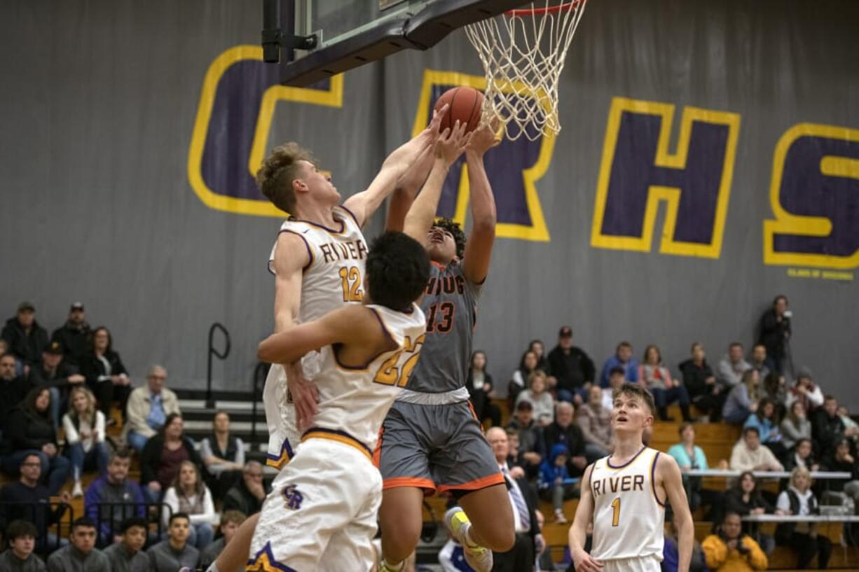 Washougalis Yanni Fassilis (13) has his shot blocked by Columbia Riveris Josh Kukula (12) at Columbia River High School on Friday night, Jan. 17, 2020.