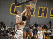 Washougalis Yanni Fassilis (13) has his shot blocked by Columbia Riveris Josh Kukula (12) at Columbia River High School on Friday night, Jan. 17, 2020.