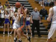 Washougalis Julien Jones (3) defends a pass from Columbia Riveris Alex Miller (3) at Columbia River High School on Friday night, Jan. 17, 2020.