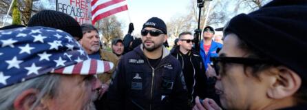 Patriot Prayer leader Joey Gibson, center, leads a protest in Portland in December 2017, a week after an undocumented Mexican resident of San Francisco was acquitted of the murder of Kate Seinle. It drew activists from both political extremes, including Kerry Hudson, left, who can be found at many Patriot Prayer rallies and Luis Enrique Marquez, right, a prominent anti-fascist protester.