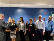 Clark County District Court Judge Darvin Zimmerman, left, swears in members of the new Ridgefield City Council at the Jan. 9 meeting: Dana Ziemer, from left, Jennifer Lindsay, Sandra Day, Rob Aichele and Lee Wells.