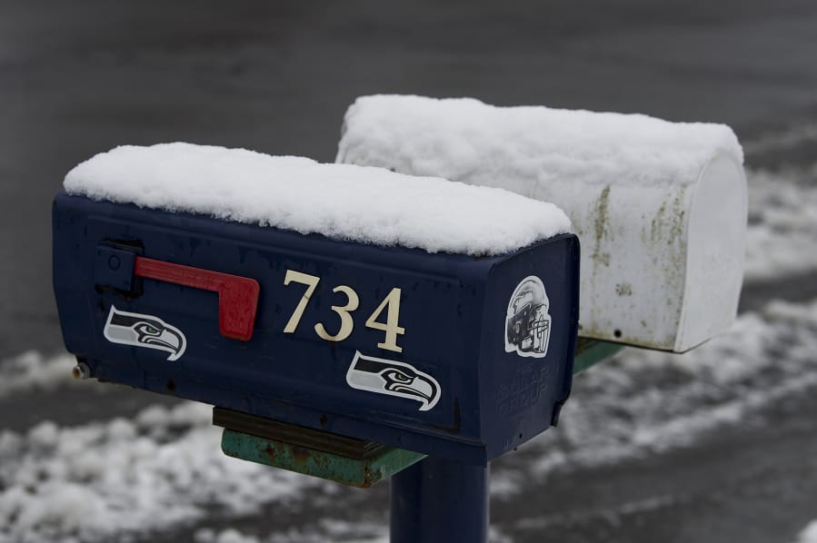 A fresh layer of snow is seen on mailboxes in the Prune Hill area of Camas on Thursday morning.