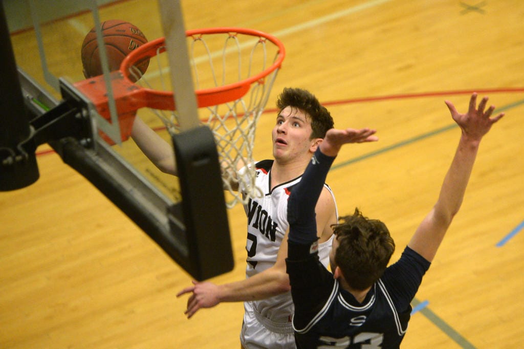 Union senior Brad Lackey shoot a layup over Skyview senior Kyle Gruhler at Union High School on Tuesday, January 21, 2020.