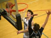 Union senior Brad Lackey shoot a layup over Skyview senior Kyle Gruhler at Union High School on Tuesday, January 21, 2020.