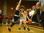 Union junior Kaden Horn dribbles around the defensive pressure from Skyview senior Sean Boss during Tuesday&#039;s 4A Greater St. Helens League matchup at Union High School. Horn scored 16 points in the Titans&#039; victory.