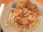 From left, Parmesan Prawn Pasta, The Pub Zookie and creme brulee at Mill Creek Pub in Battle Ground.